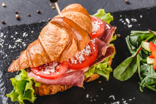 Croissant with prosciutto and tomatoes