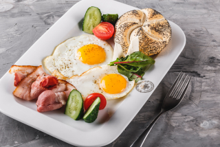 Aried eggs with bacon and vegetables