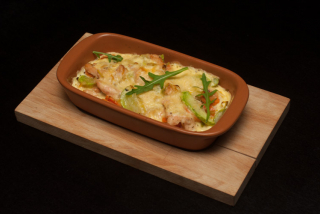 Salmon baked in creamy sauce with zucchini, carrots and leek